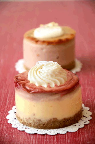 Image of a strawberry and cream cheesecake topped with whipped cream.