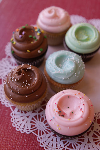 Assorted Traditional Cupcakes with assorted pastel buttercream frostings and chocolate buttercream.