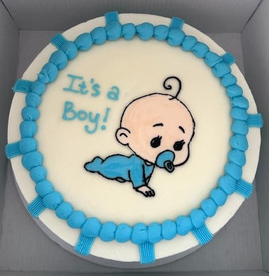 Baby shower cake with 'It's a Boy!' text and baby illustration on white background