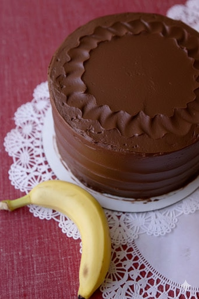 Chocolate cake with a banana on a red tablecloth