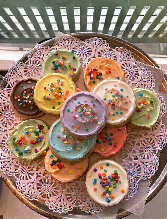 Colorful cookies with sprinkles on a decorative plate
