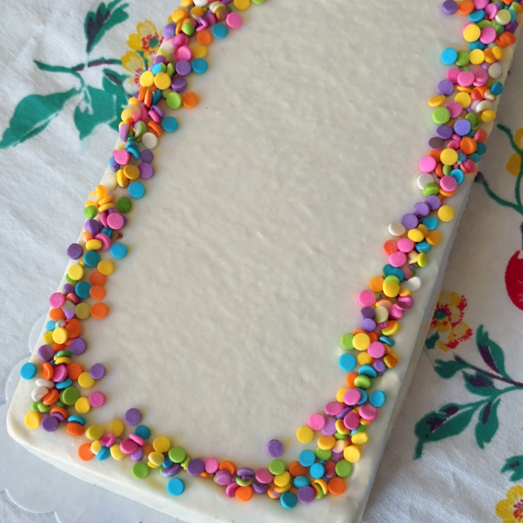 Decorative border of colorful polka dots on a white surface with floral patterns.