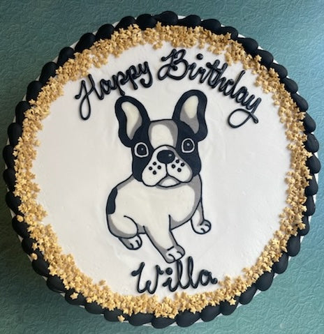 Birthday cake with a dog illustration and 'Happy Birthday Willa' text on a teal background