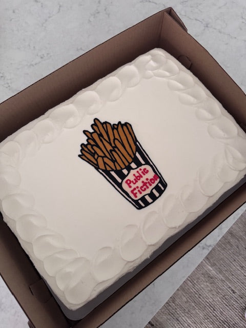Rectangular cake with hand-drawn french fries in a black and white striped paper cup.