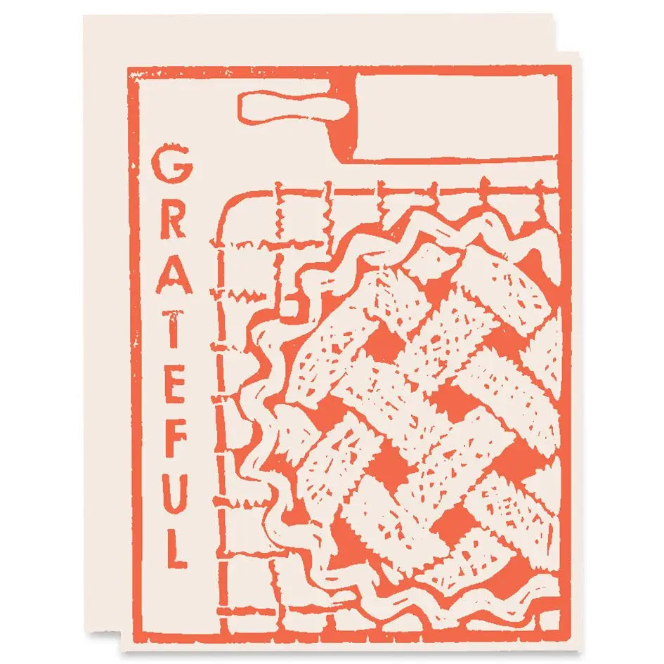 Card with red and white design and 'GRATEFUL' text on a beige background