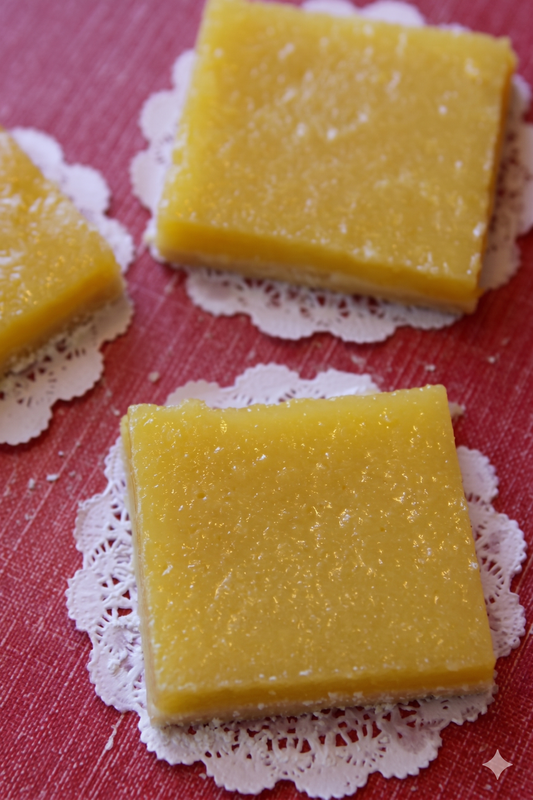 Lemon bars on white doilies with a red background