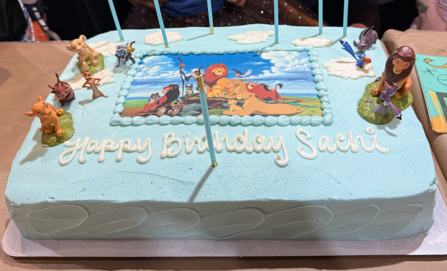 Birthday cake with 'Happy Birthday Sacha' on a table