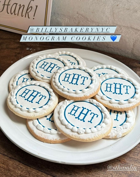 Monogrammed cookies on a plate with 'BILLY'S BAKERY NYC' branding.